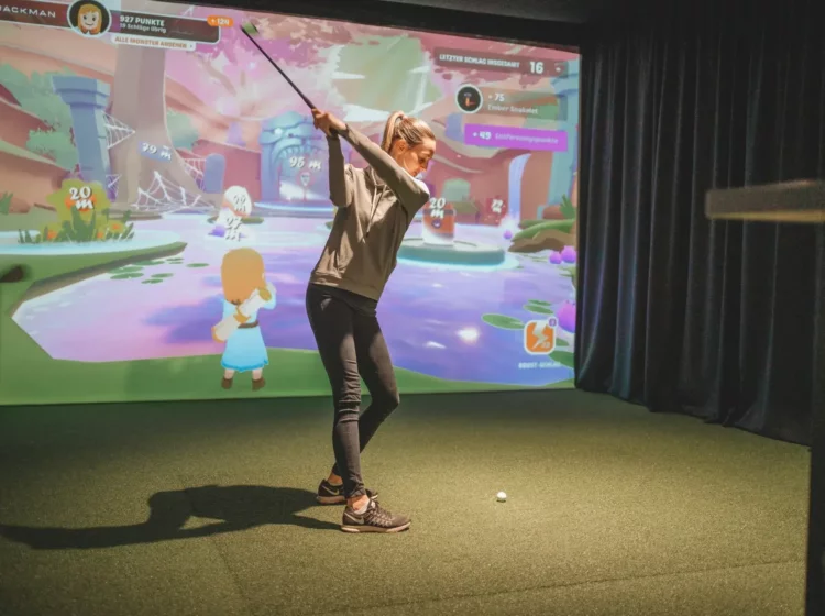 Frau spielt Indoorgolf im Reiters